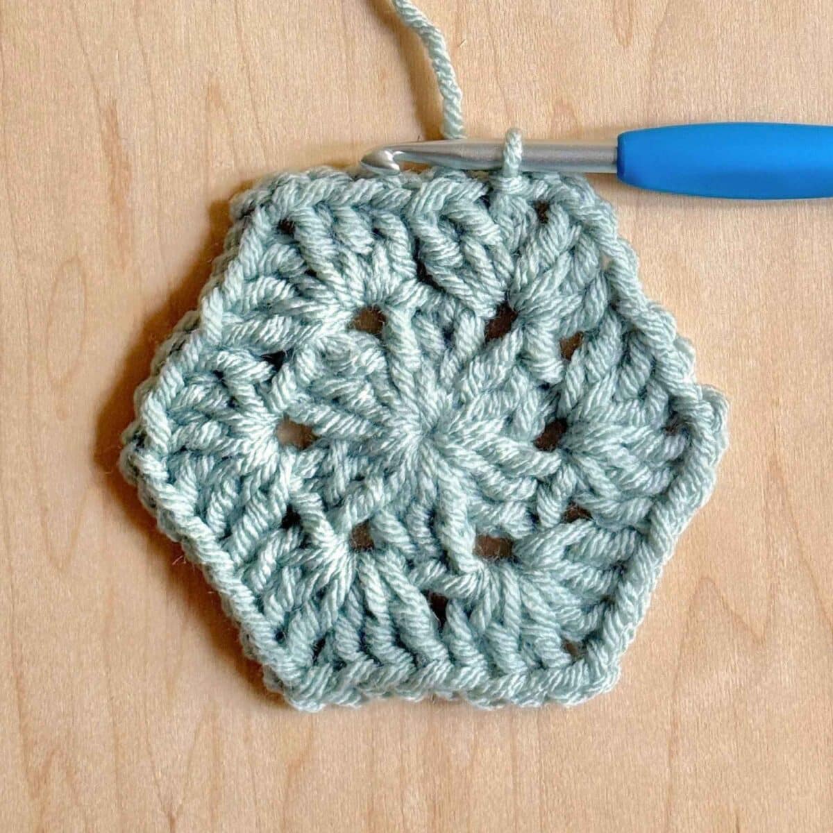 Process photo showing round 3 of the crochet hexagon.